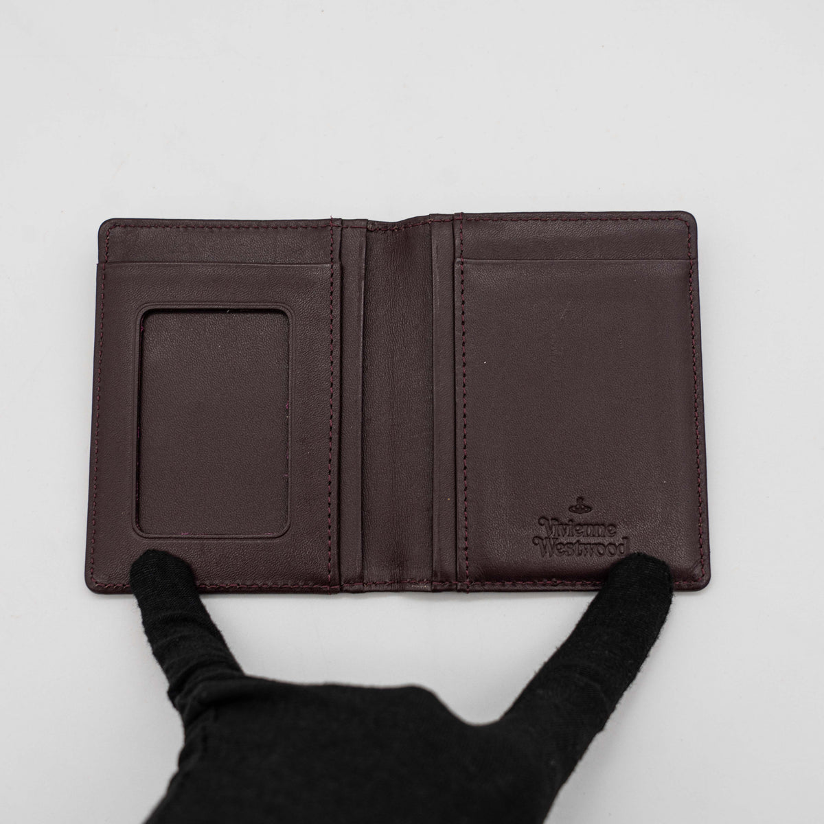 Vivienne Westwood card case in purple tartan canvas with gold Orb logo and burgundy leather interior.