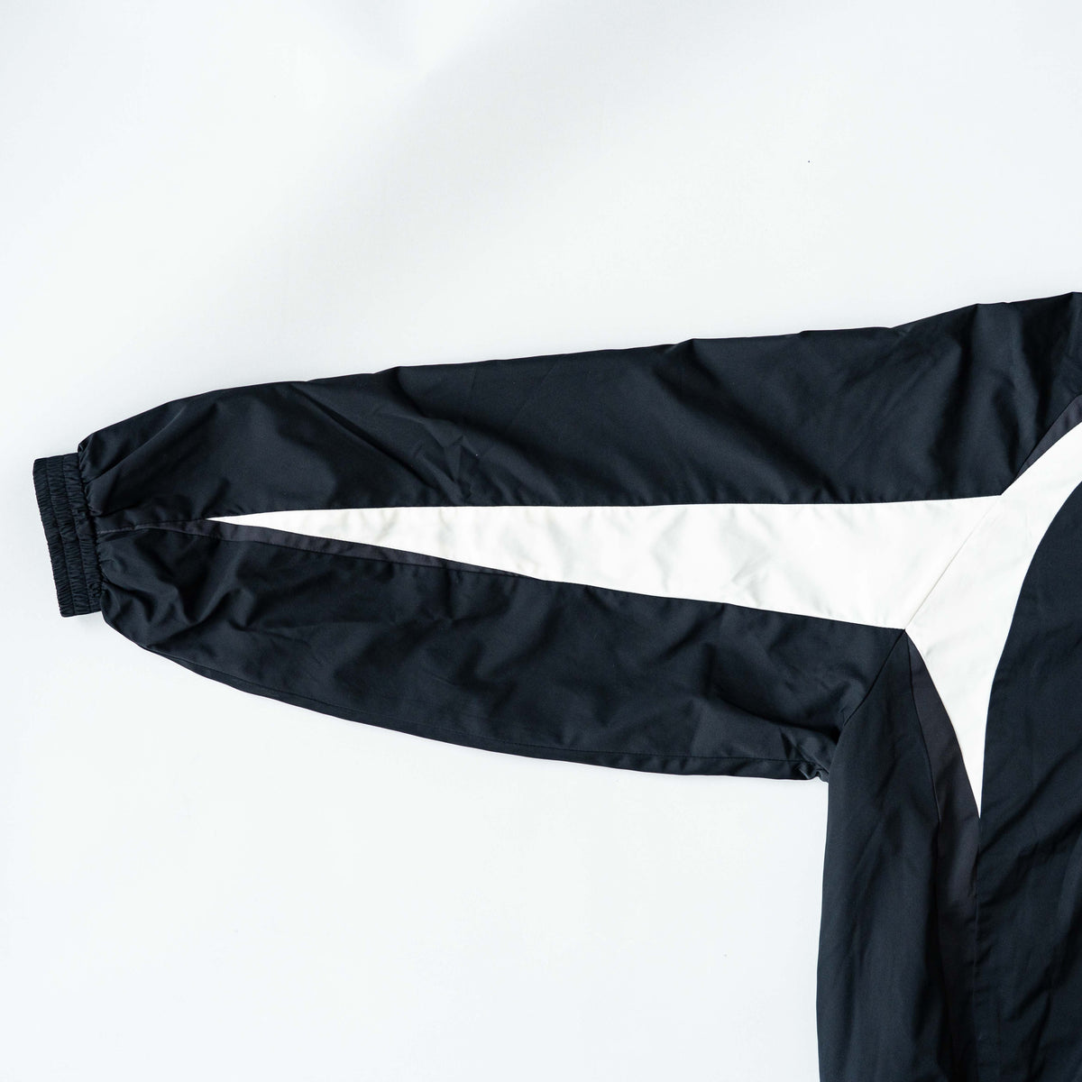 BAPE A Bathing Ape black and white logo track jacket with bold panel detailing, shown laid flat.