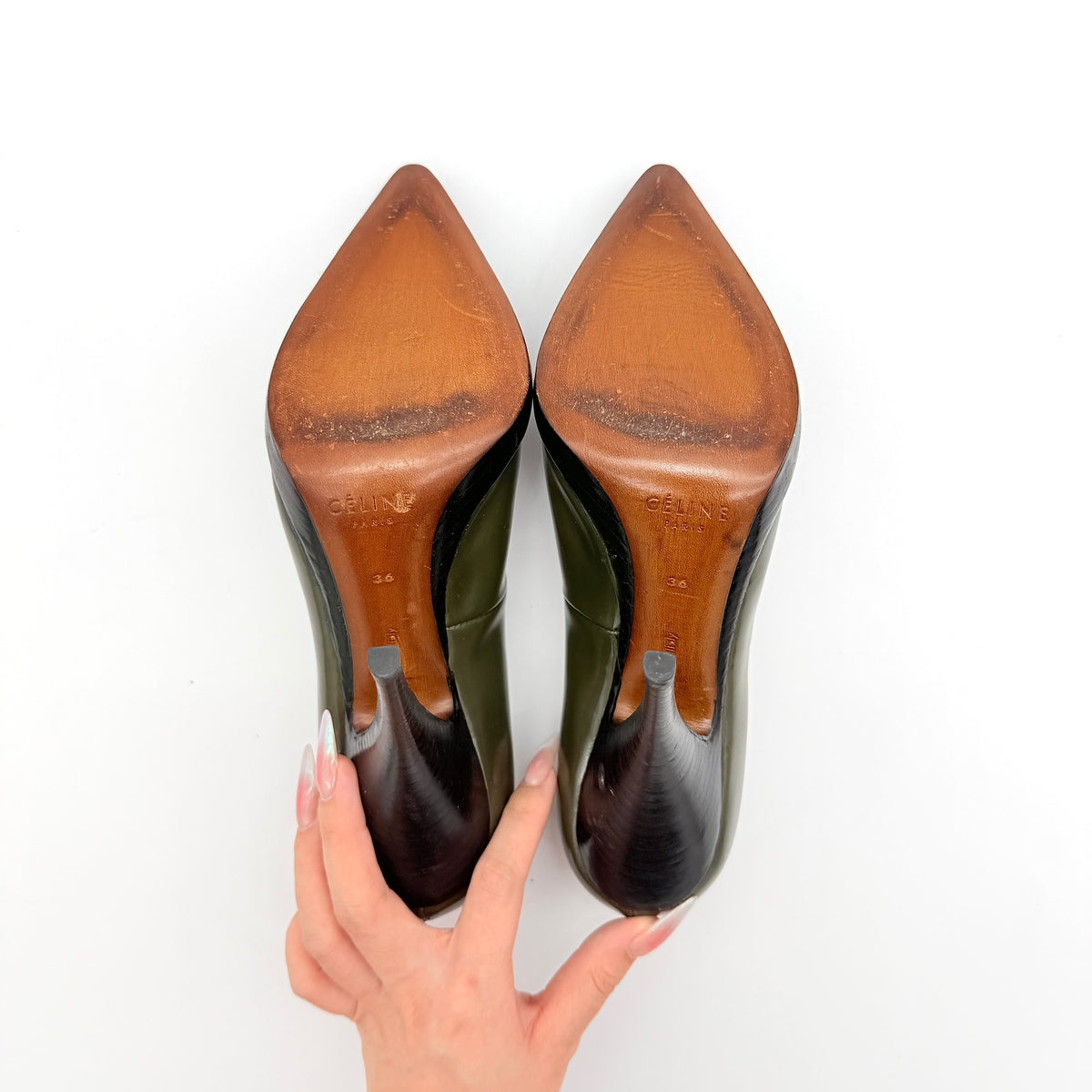 Celine olive green leather heels with pointed toe and black stiletto heel, displayed against a white background