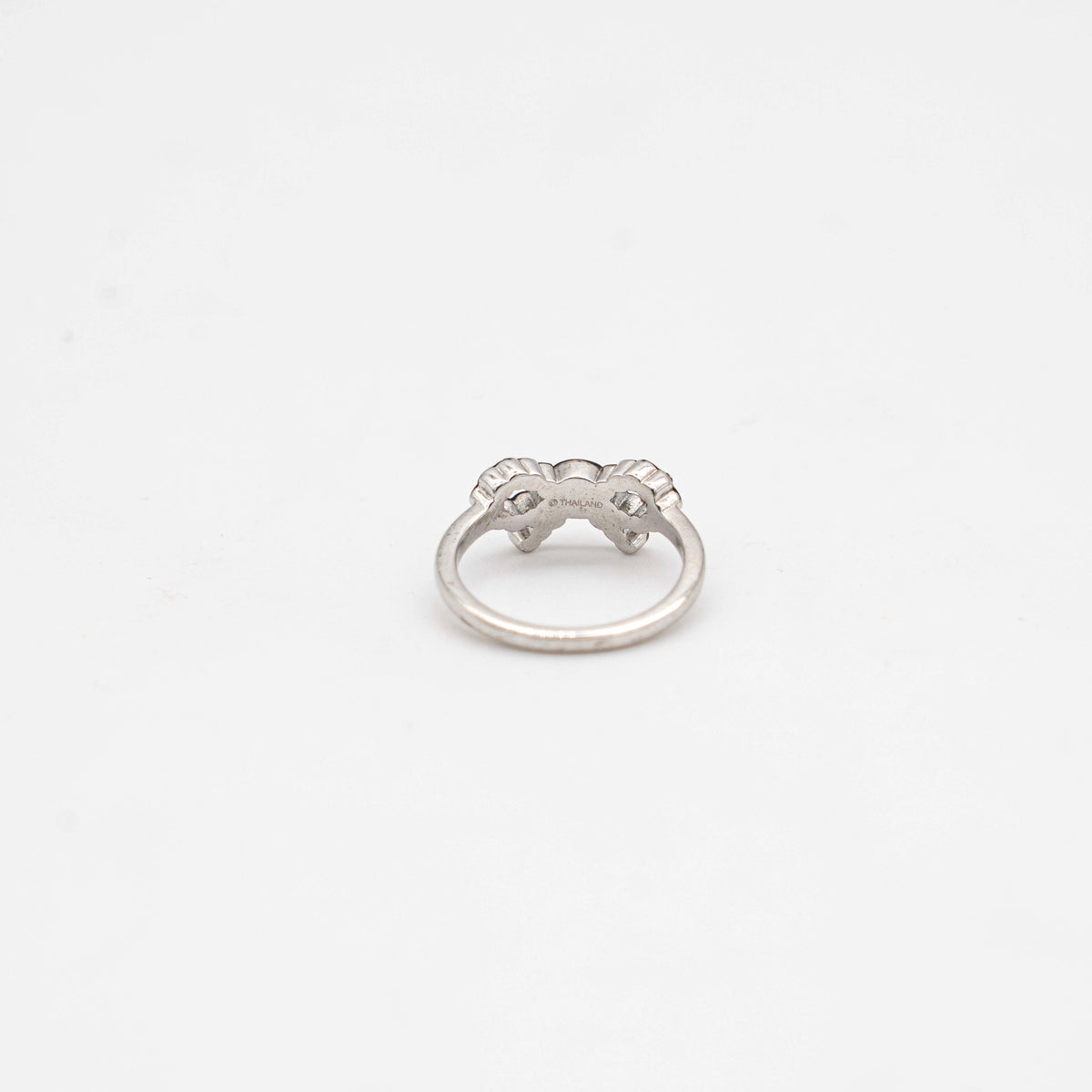 Coach silver ring with a rhinestone-encrusted bow motif, photographed against a white background.