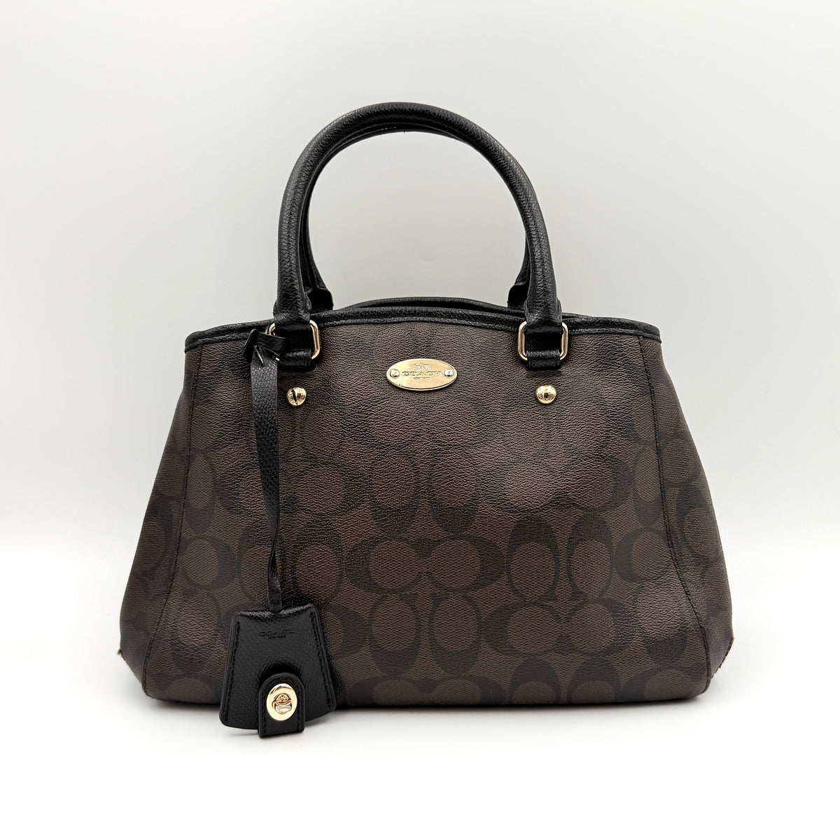 Coach 2Way Signature Margot Carryall Satchel in brown with black leather handles and gold hardware, shown with detachable strap.