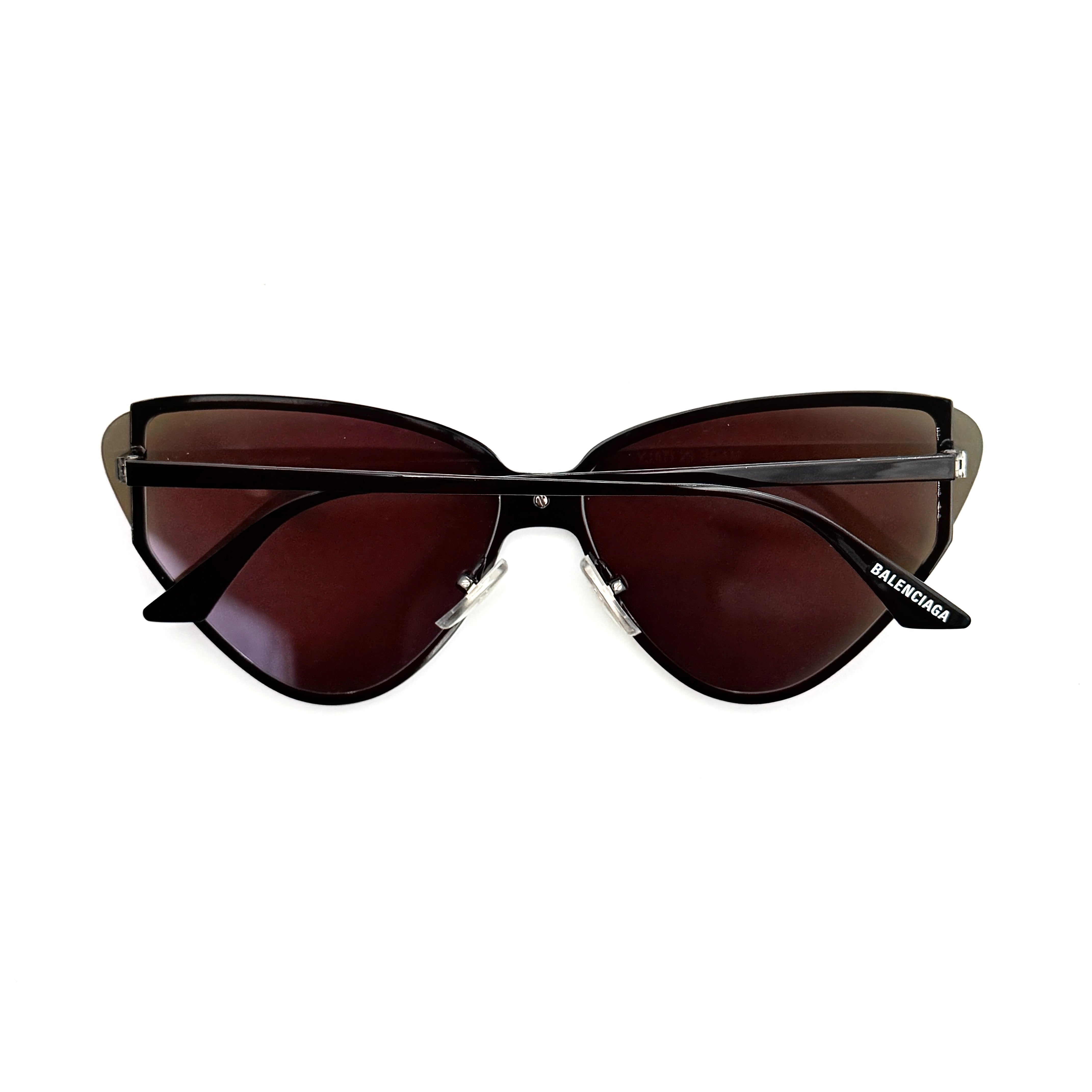 Balenciaga cat-eye sunglasses with purple mirrored lenses and black frame, featuring signature BB logo at the bridge.