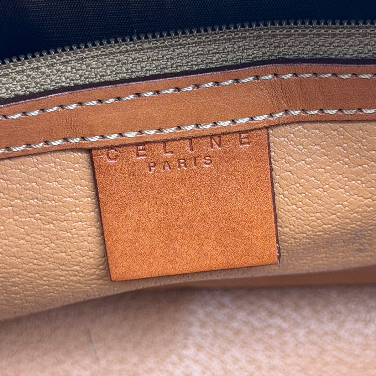 Front view of the Celine Triomphe Macadam Dome Handbag in brown, featuring the signature monogram canvas and tan leather details.