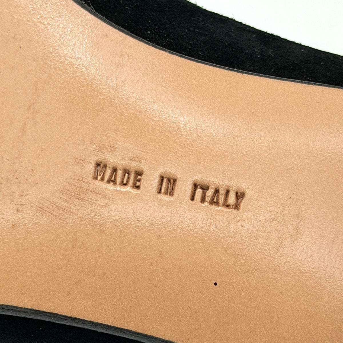 Salvatore Ferragamo black suede loafers with gold Gancini horsebit detail, displayed side by side on a white background.