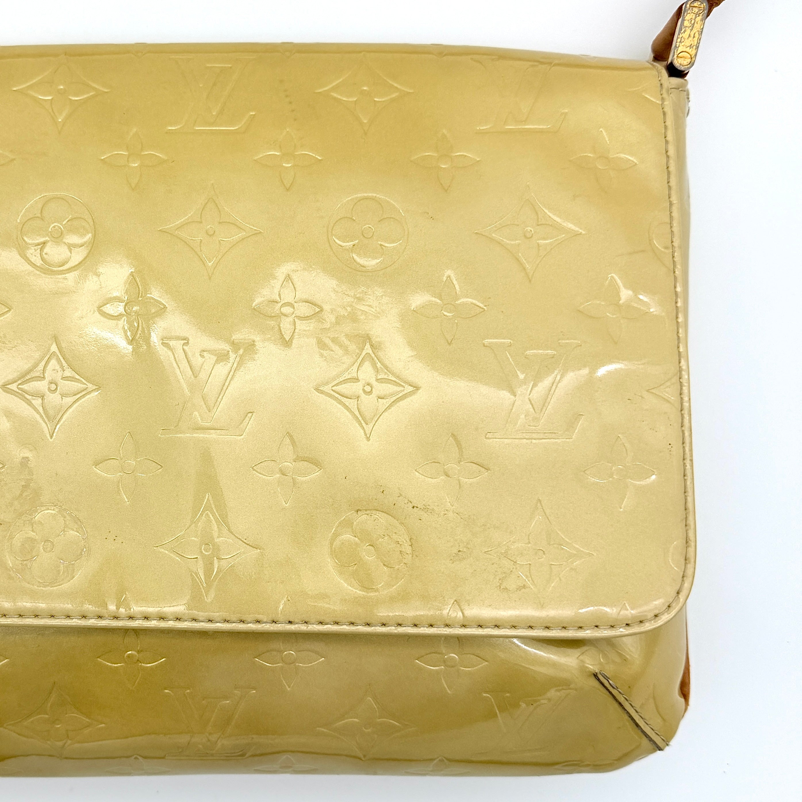 Louis Vuitton Thompson Street bag in yellow Monogram Vernis leather with adjustable shoulder strap and gold-tone hardware.