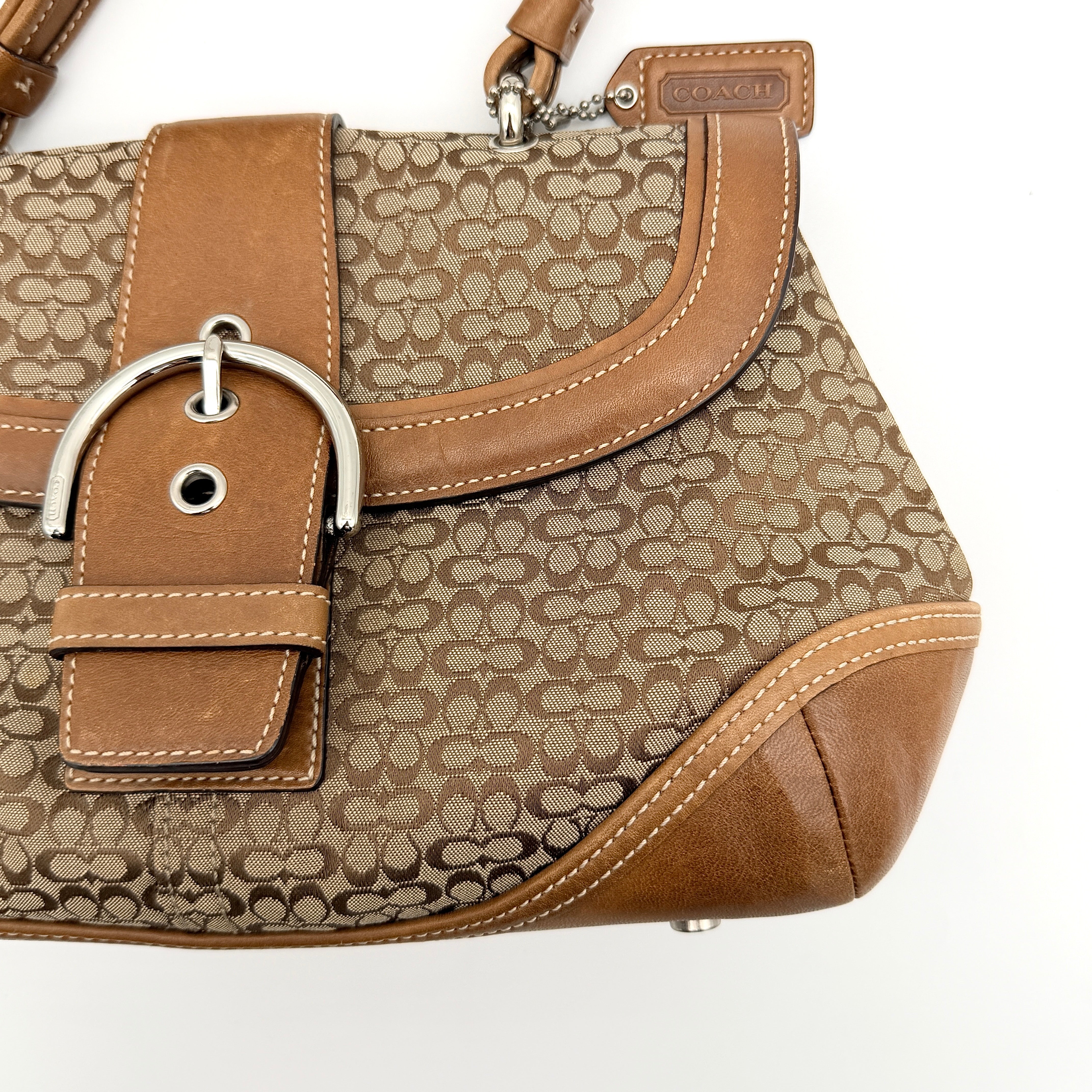 Coach Signature Soho Shoulder Bag in beige and tan monogram canvas with tan leather trim, shown on white background.