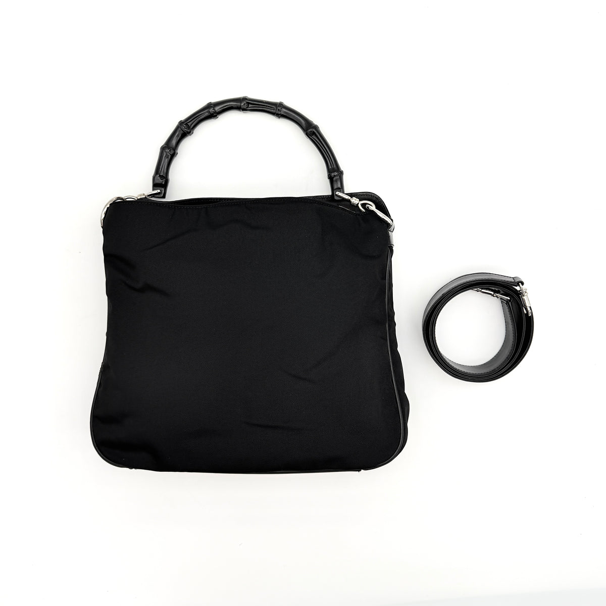 Gucci black nylon shoulder bag with bamboo handle and detachable strap shown with dust bag.