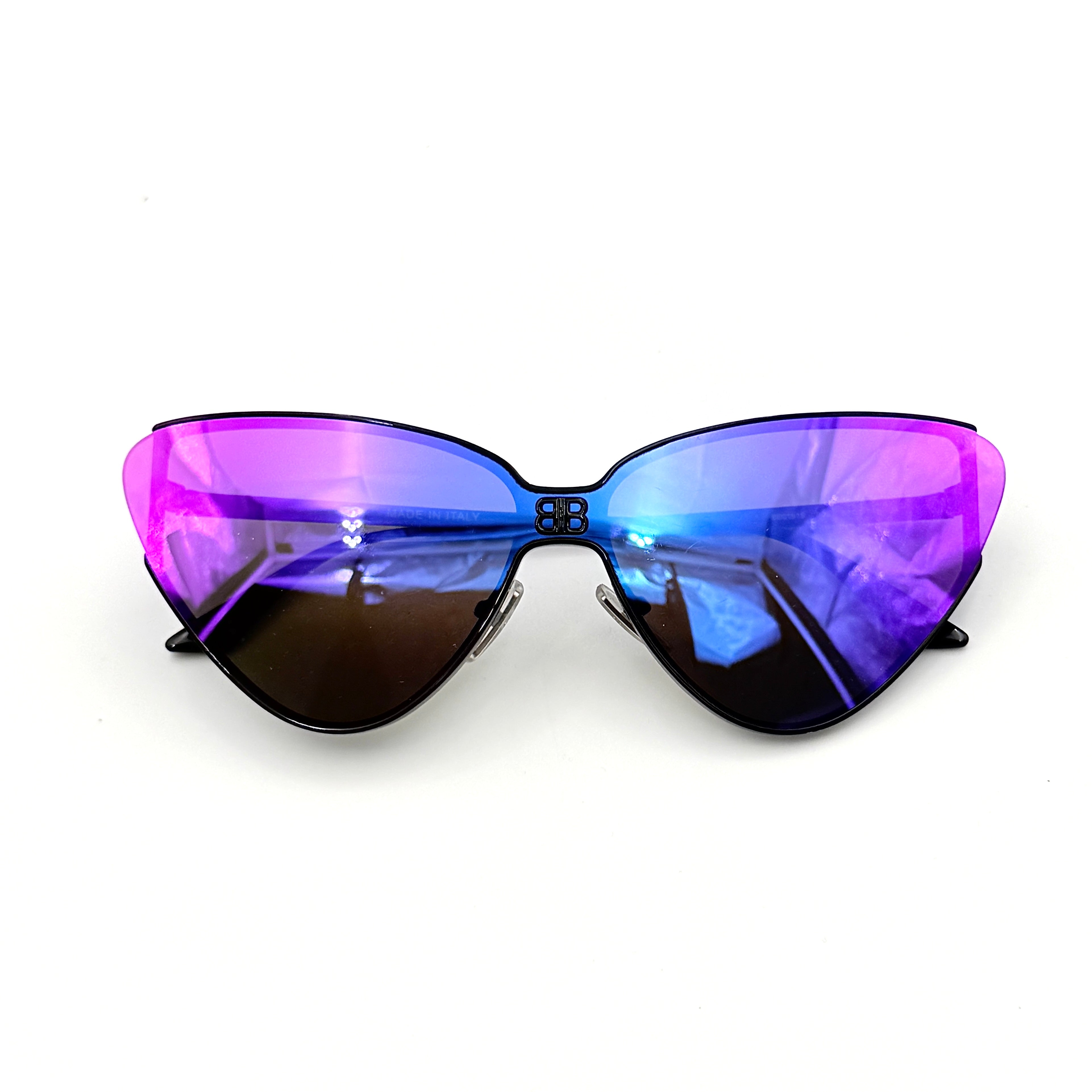 Balenciaga cat-eye sunglasses with purple mirrored lenses and black frame, featuring signature BB logo at the bridge.