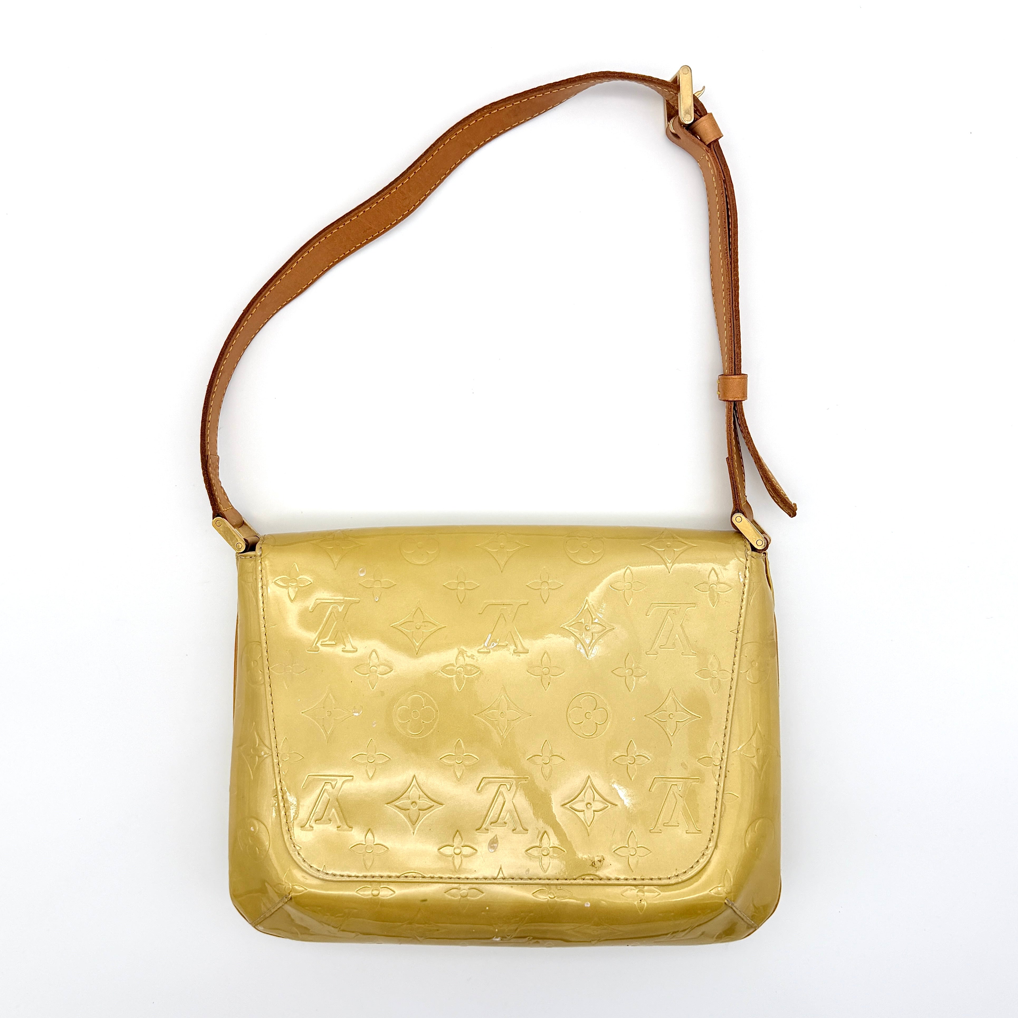 Louis Vuitton Thompson Street bag in yellow Monogram Vernis leather with adjustable shoulder strap and gold-tone hardware.