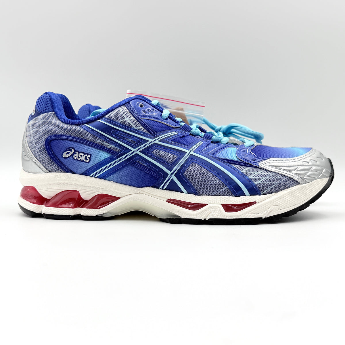 ASICS x KITH Gel-Nimbus 10.1 Mega Man sneakers in bold blue and silver, displayed with extra laces and distinctive collaboration details.