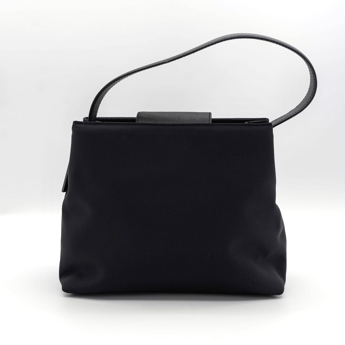 Coach Mercer tote bag in black nylon with leather handle and trim, presented against a white background.