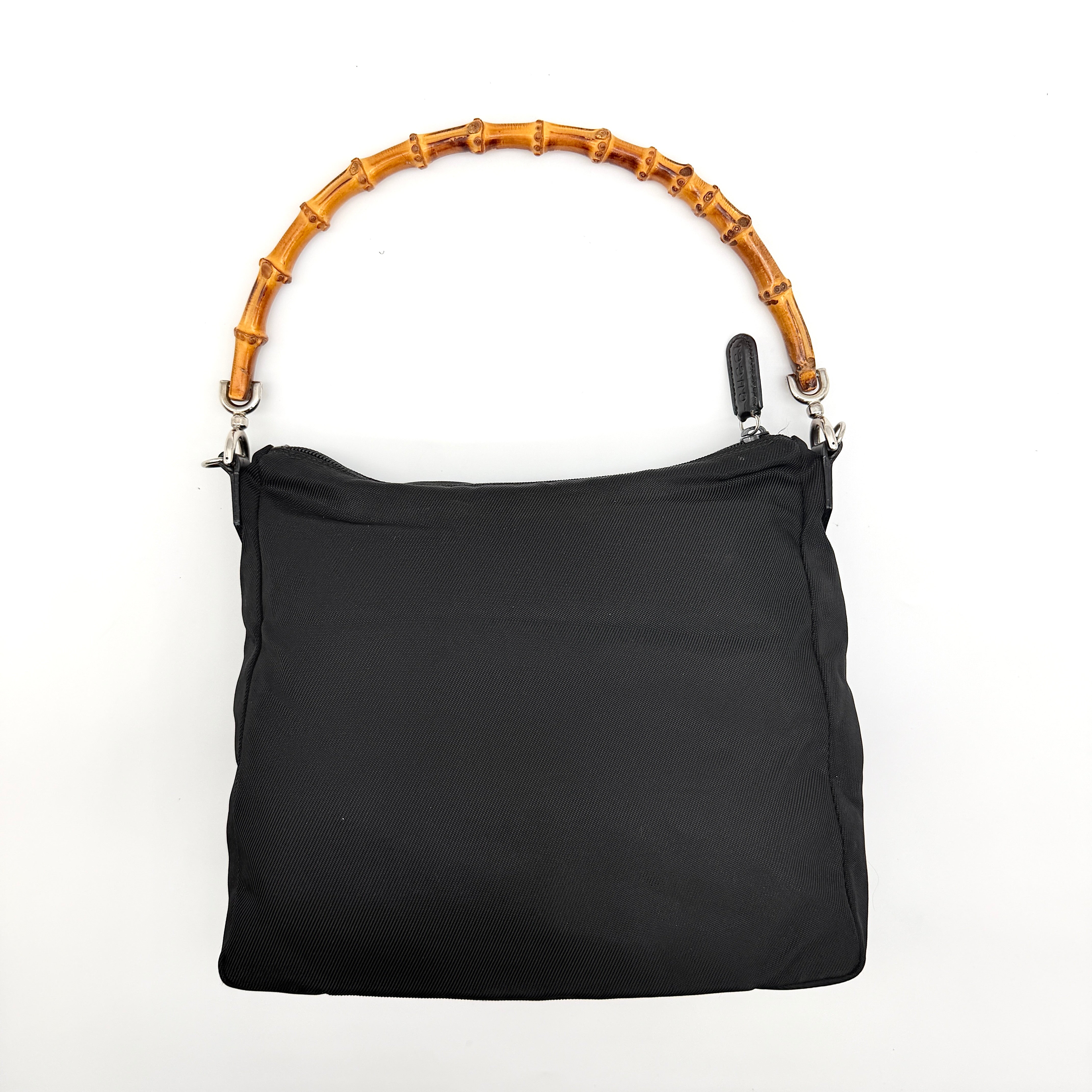 Gucci nylon shoulder bag in black with bamboo handle, shown against a white background.