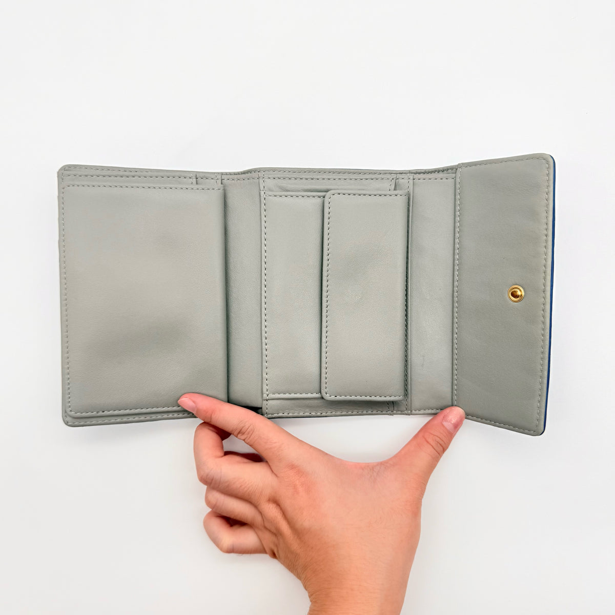 Vivienne Westwood blue leather trifold wallet with gold Orb emblem, shown with original box and documents.