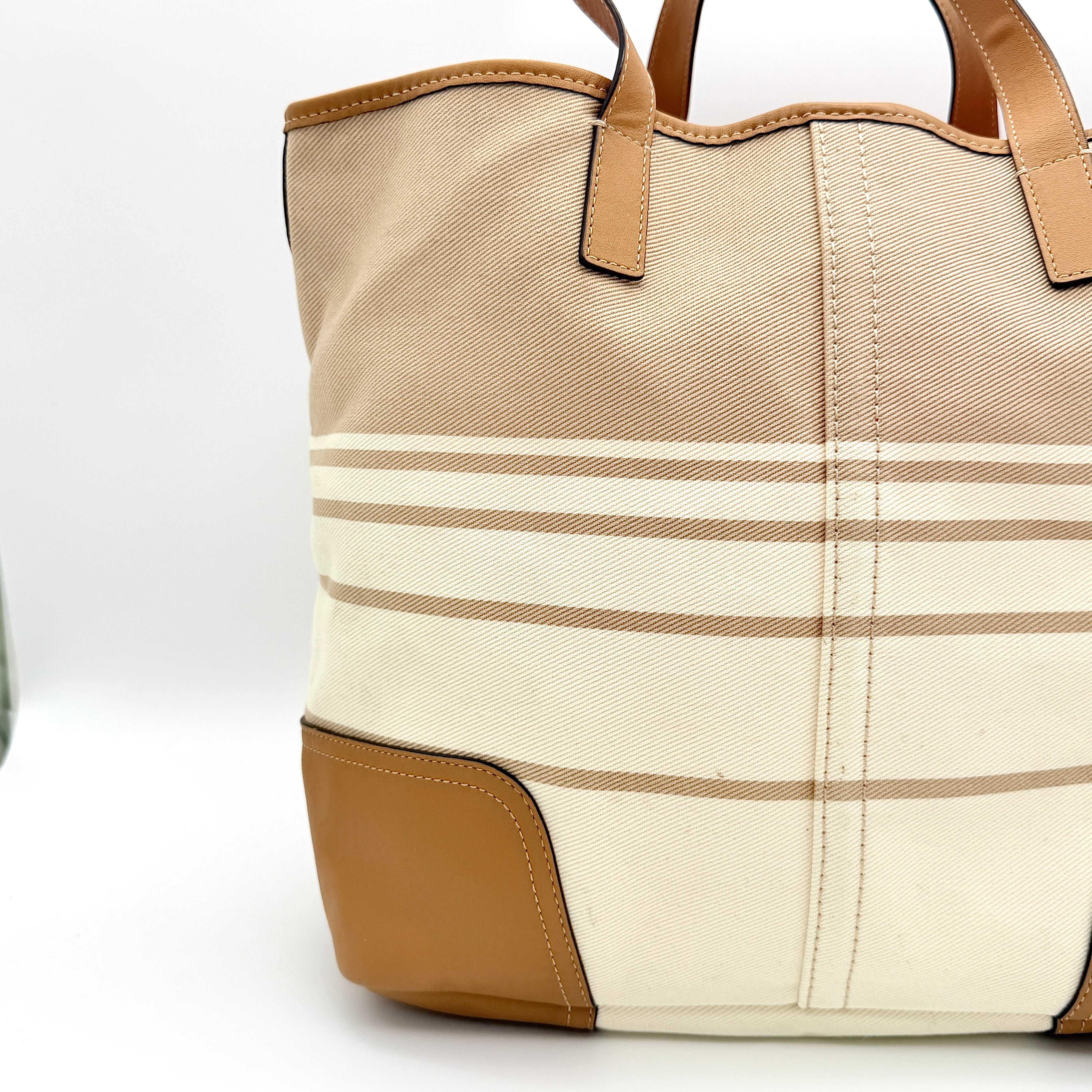 Coach Hadley Variegated Stripe Handbag in beige and tan canvas with leather trim, shown with top handles and detachable strap.