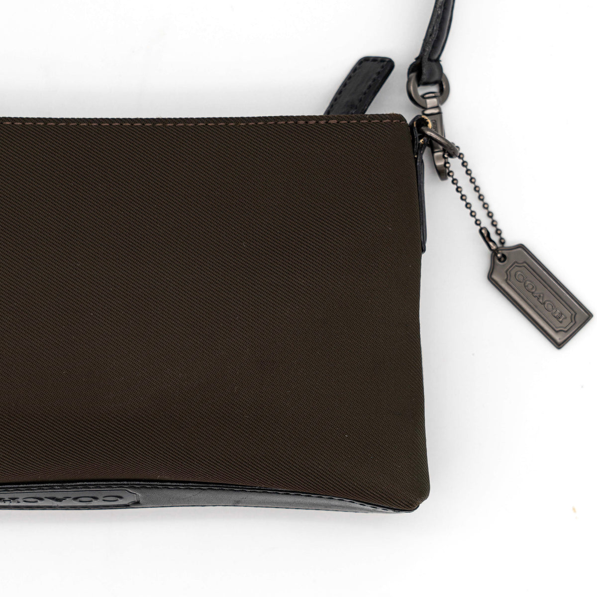 Coach Mercer Demi Tote Bag in brown nylon with black leather trim and gunmetal hardware, shown with signature Coach tag.