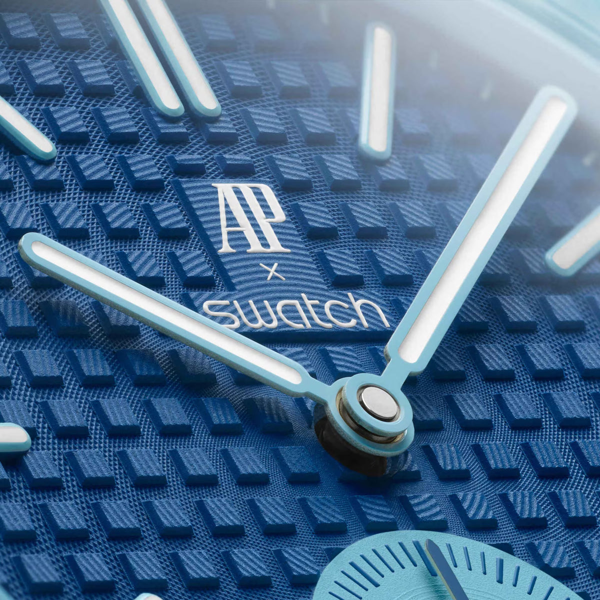 A Swatch x Audemars Piguet Royal Pop Lan Ba pendant watch in blue, featuring a geometric case, textured dial, and stitched blue strap.