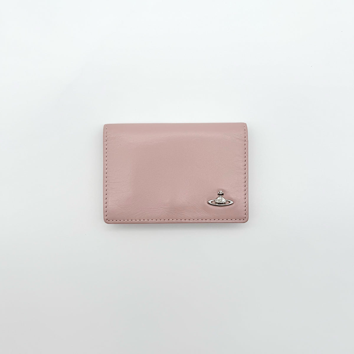 Vivienne Westwood light pink leather card case with silver-tone Orb emblem and sleek, structured design.