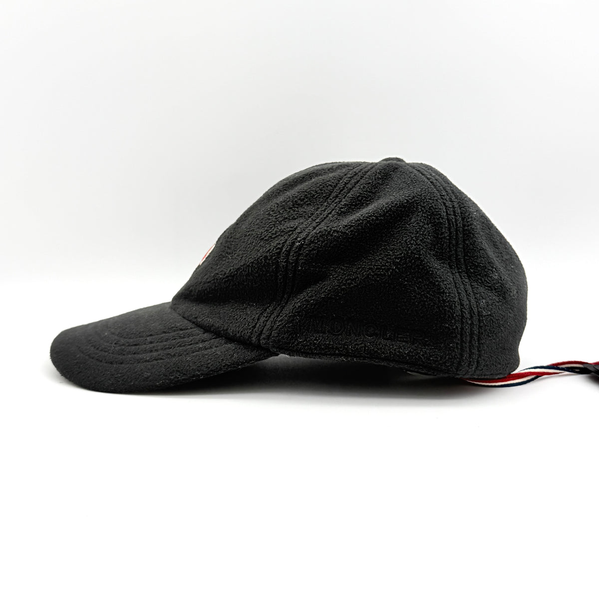Moncler Grenoble black fleece baseball cap with tri-colour logo patch on the front and tonal embroidery details.