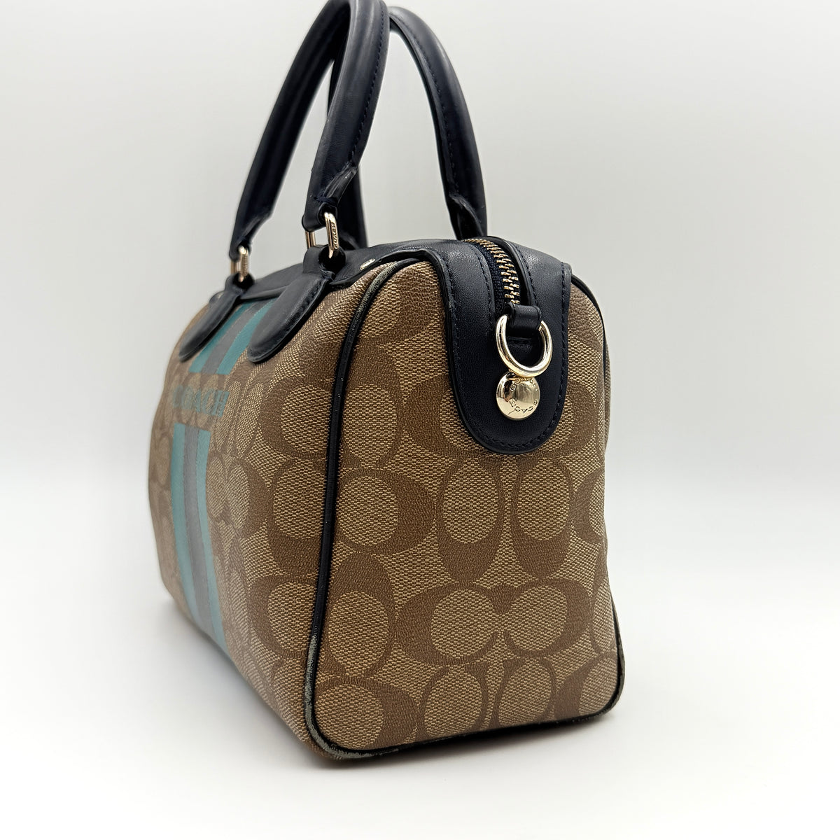 Coach Signature Mini Bennett Boston Bag in monogram canvas with navy and teal varsity stripes and dark navy leather trim.