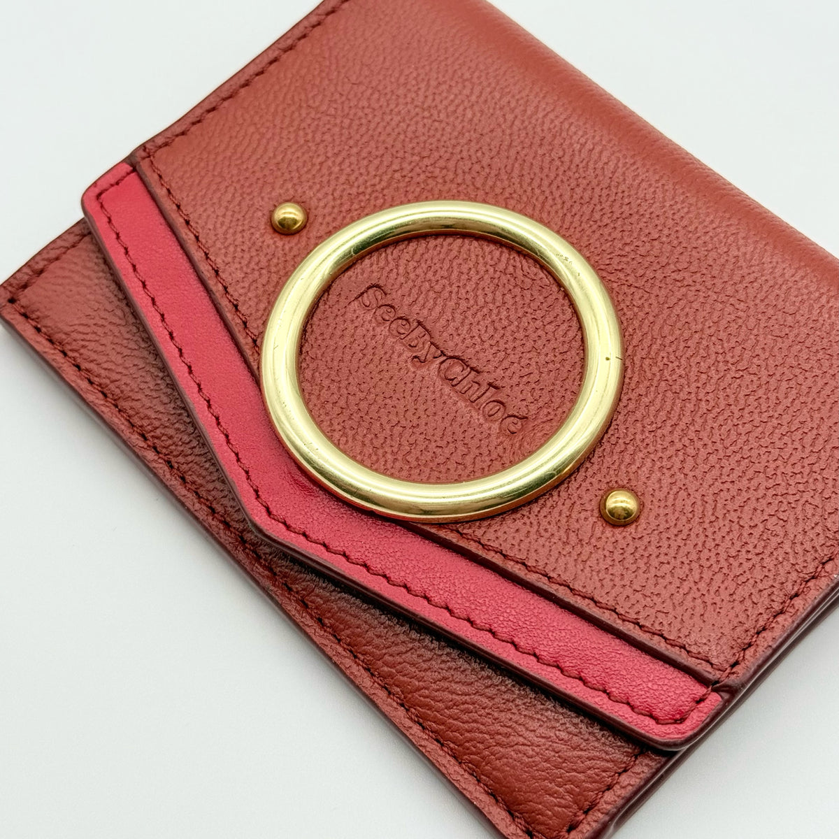 See by Chloé red leather card case with gold-tone ring detail, shown with authenticity card.