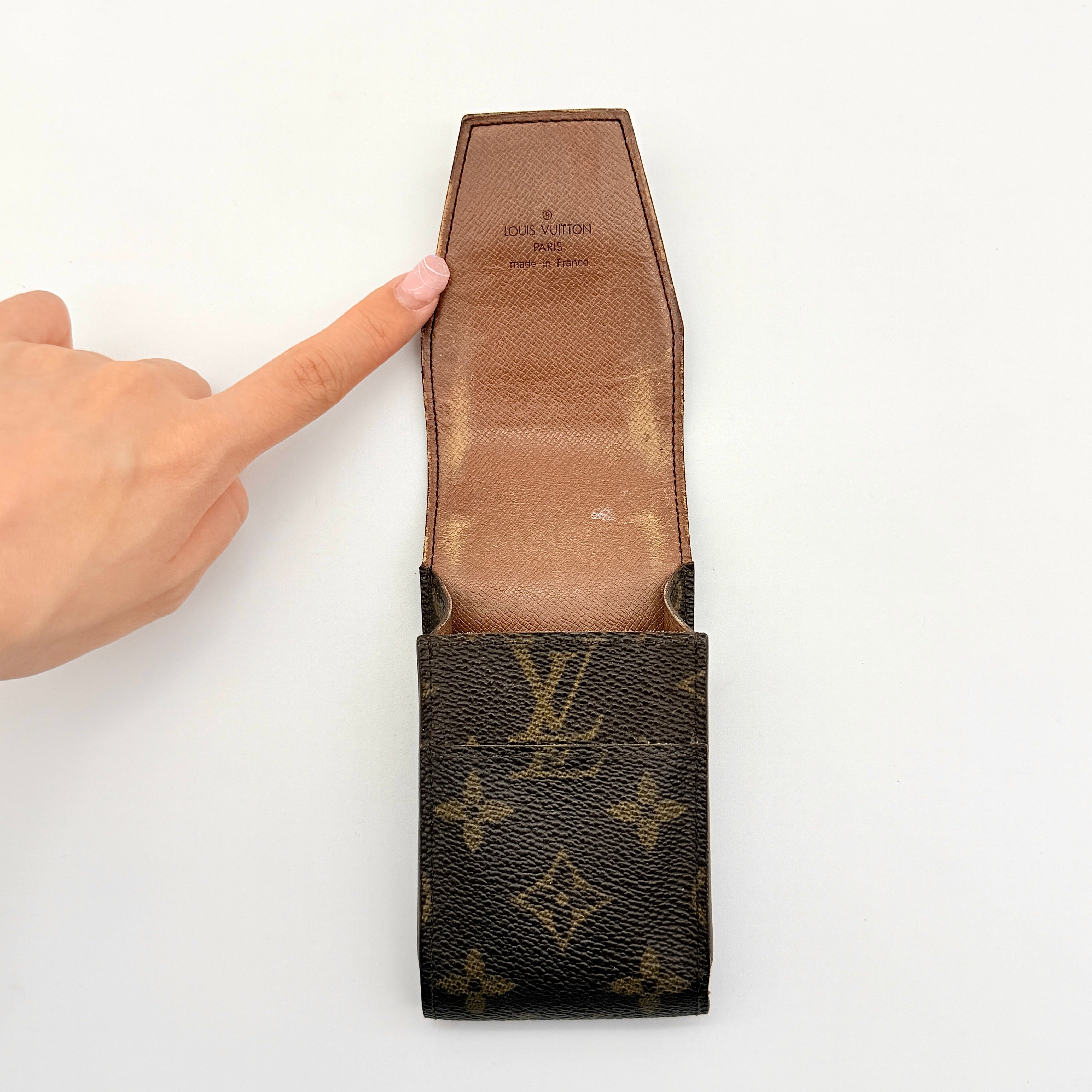 Louis Vuitton Monogram cigarette case in brown coated canvas with flap top, shown from the front.