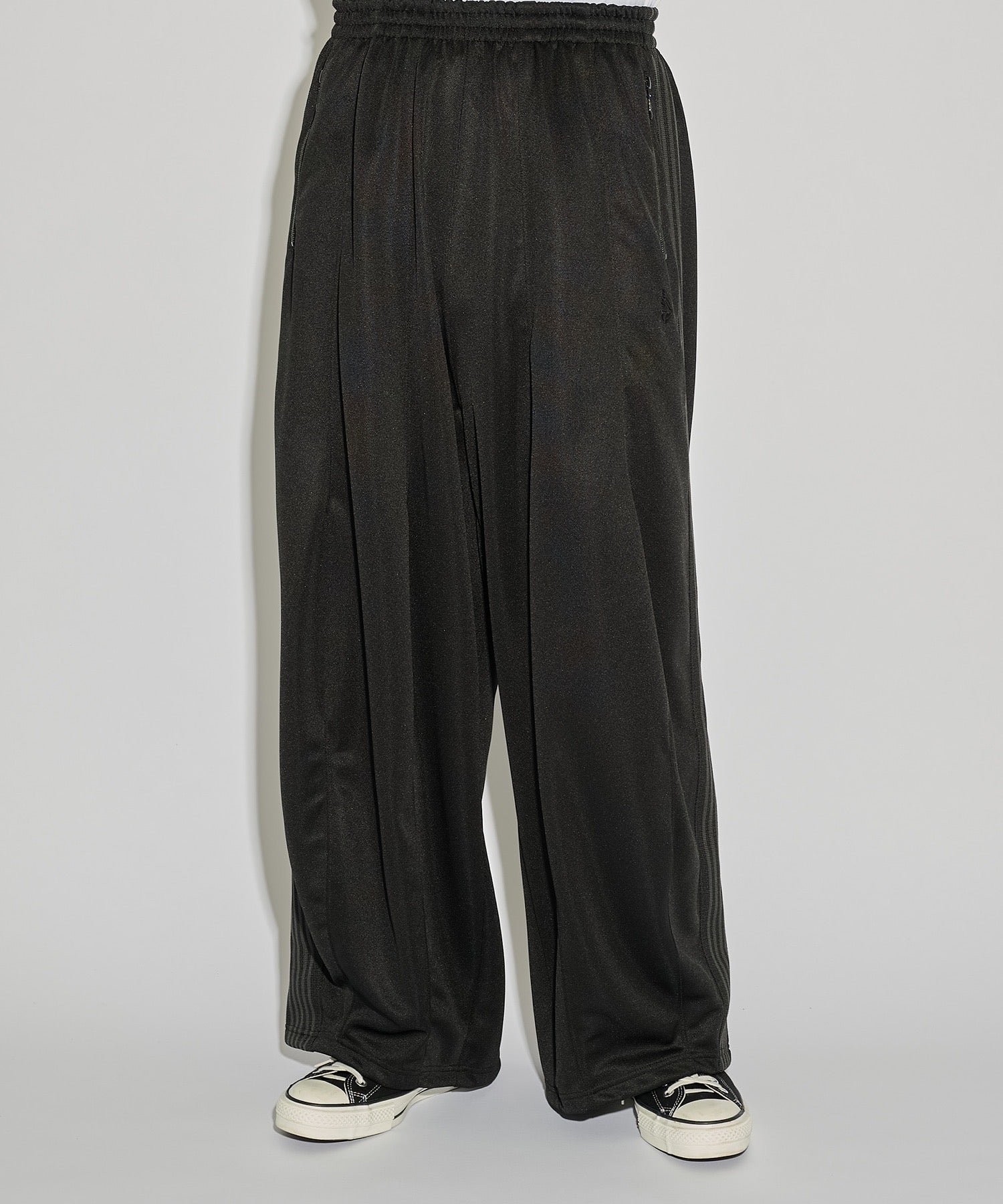 Needles H.D. Track Pant in black with tonal butterfly embroidery and relaxed wide-leg cut, photographed on model.