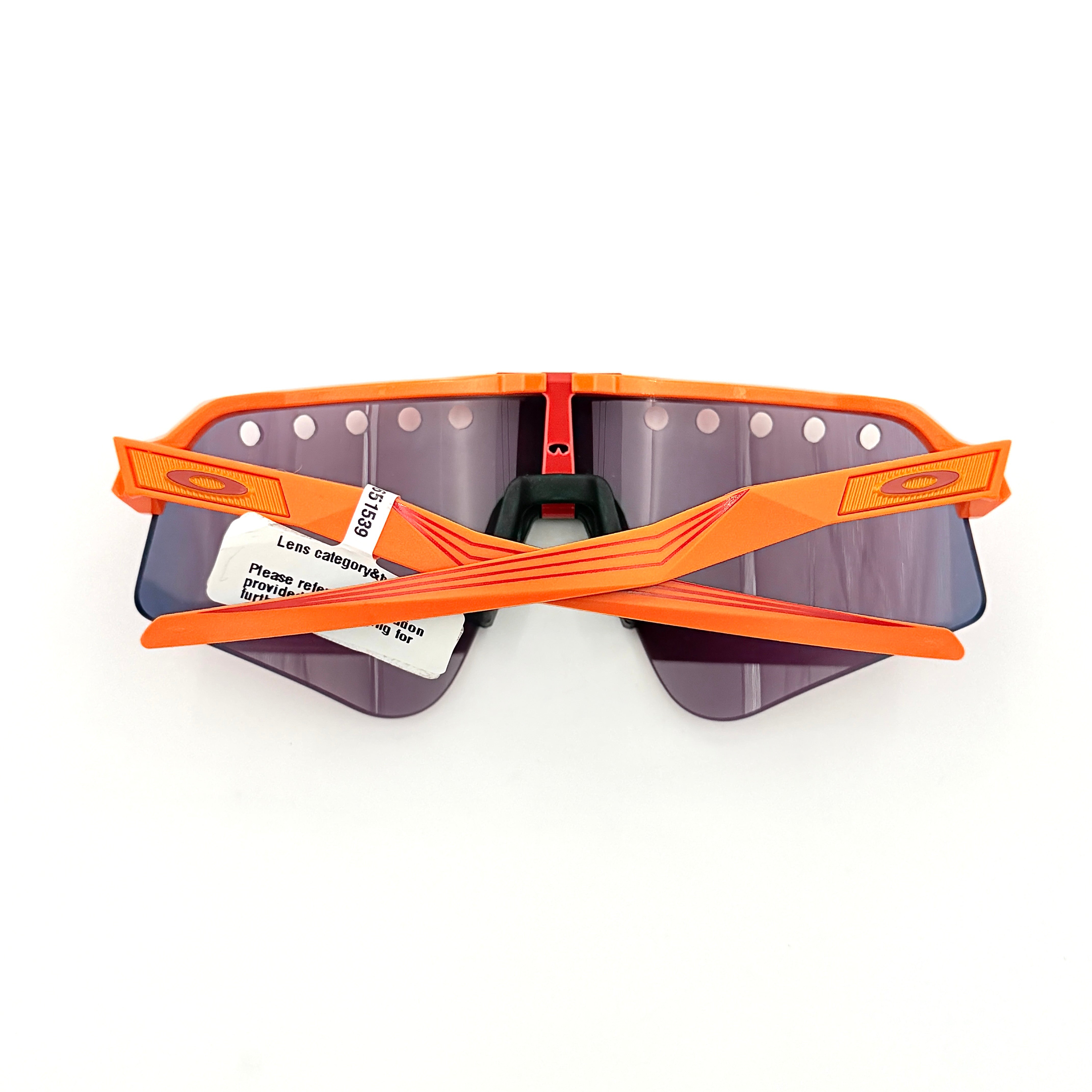Oakley Sutro Lite Sweep MVDP Prizm Road sunglasses in orange sparkle with a shield lens and original pouch, photographed in bright studio lighting.
