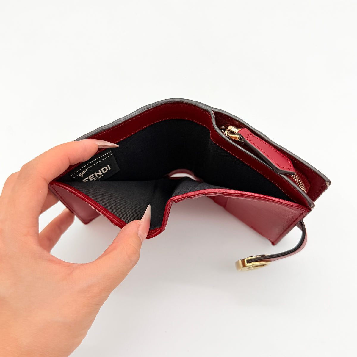 Fendi FF Embossed Logo Bifold Wallet in brown with red strap and gold Fendi hardware, displayed front on white background