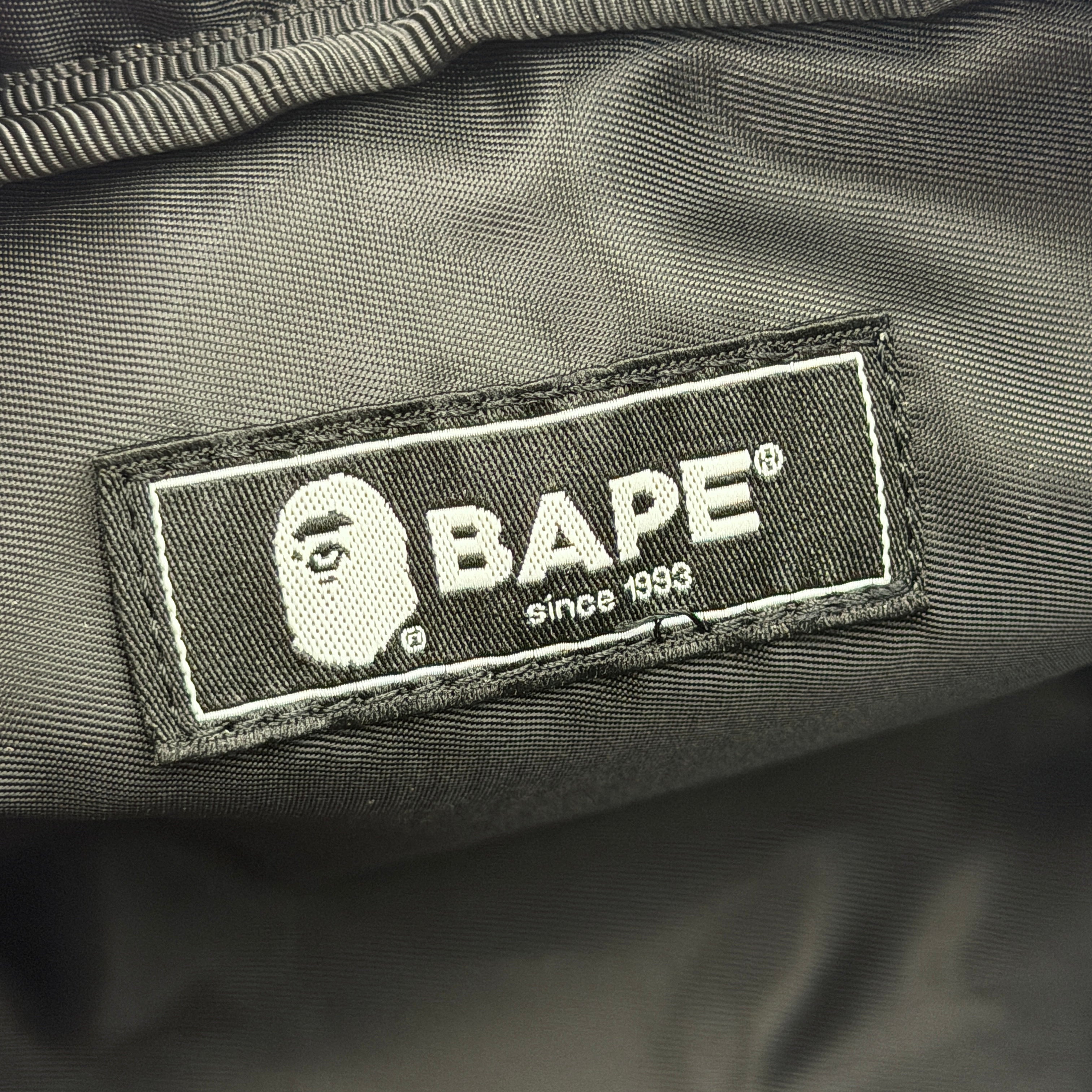 BAPE ABC Camo Pouch in green camouflage with mesh front pocket and embroidered A Bathing Ape logo.