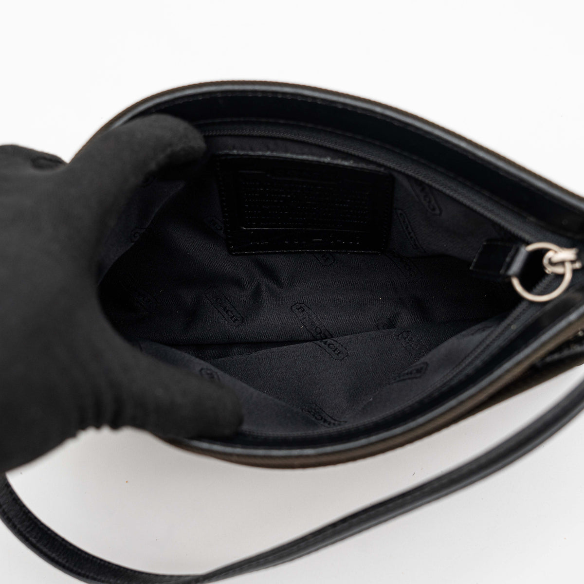 Coach Mercer Demi Tote Bag in brown nylon with black leather trim and gunmetal hardware, shown with signature Coach tag.