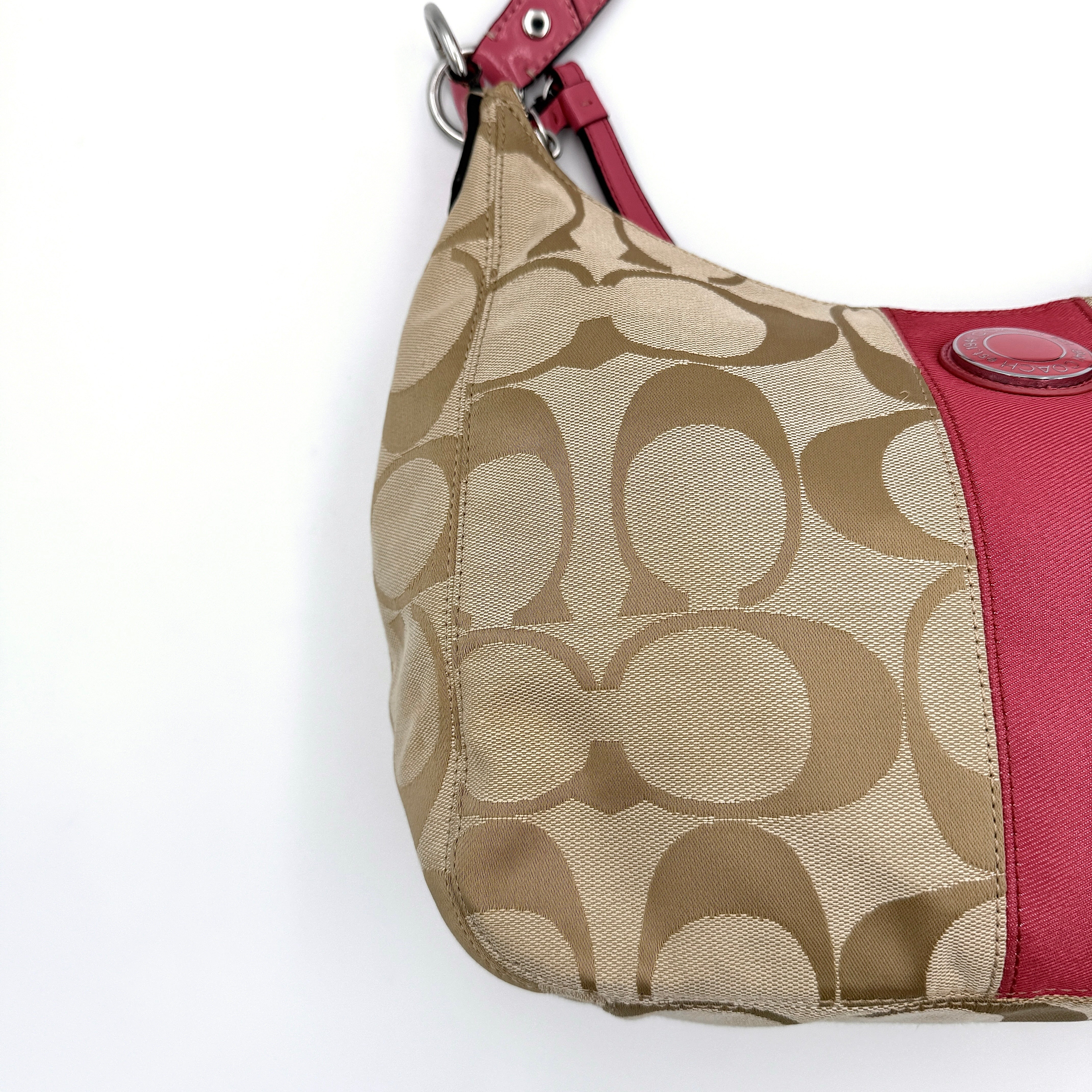 Coach Signature Stripe Hobo Shoulder Bag in beige jacquard canvas with bold pink central stripe and pink leather shoulder strap.