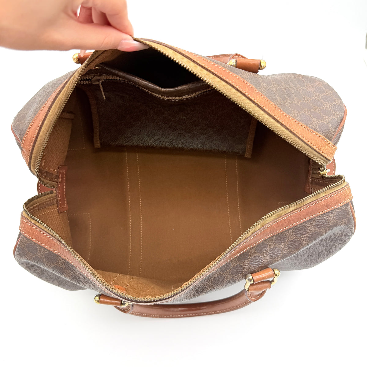 Celine Macadam Triomphe Boston Bag in brown coated canvas with tan leather and gold-tone hardware, shown against a white background.
