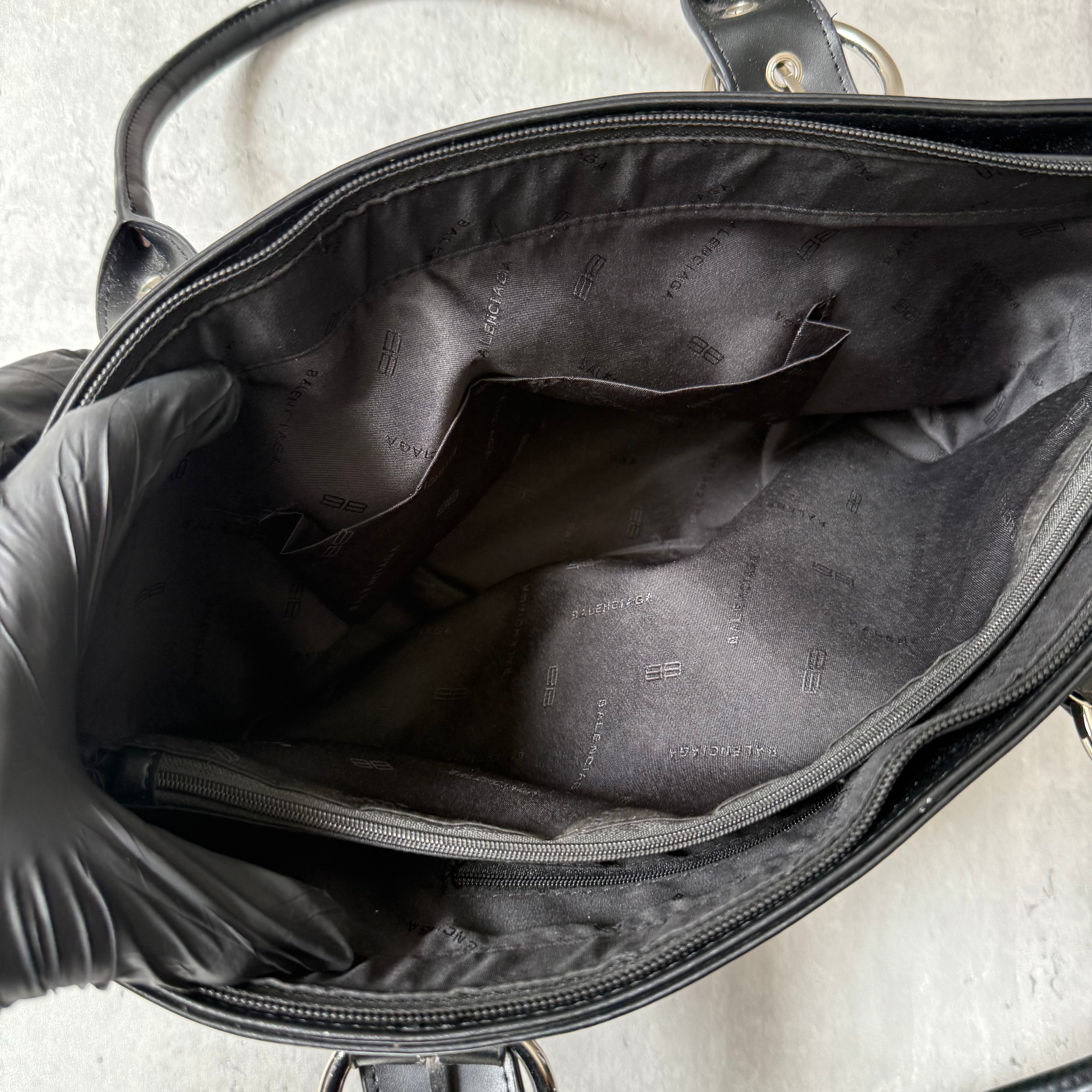 Balenciaga BB Logo Handbag in black canvas with leather trim, dual top handles, and zippered compartment interior.