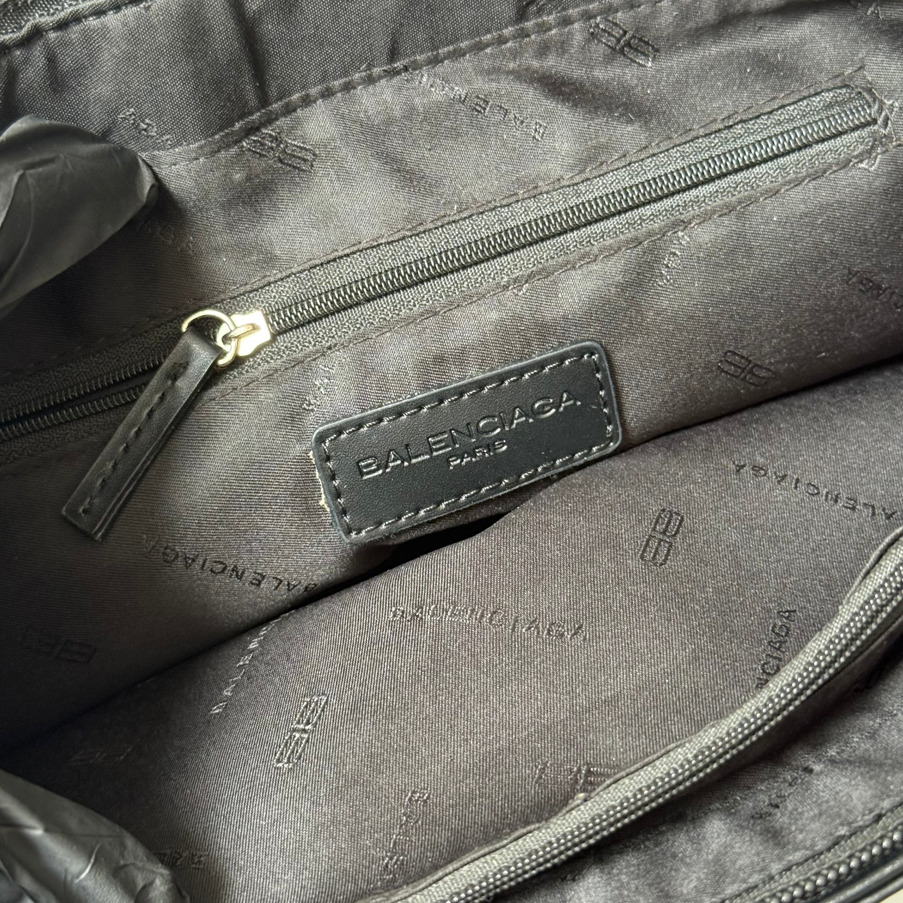 Balenciaga BB Logo Handbag in black canvas with leather trim, dual top handles, and zippered compartment interior.