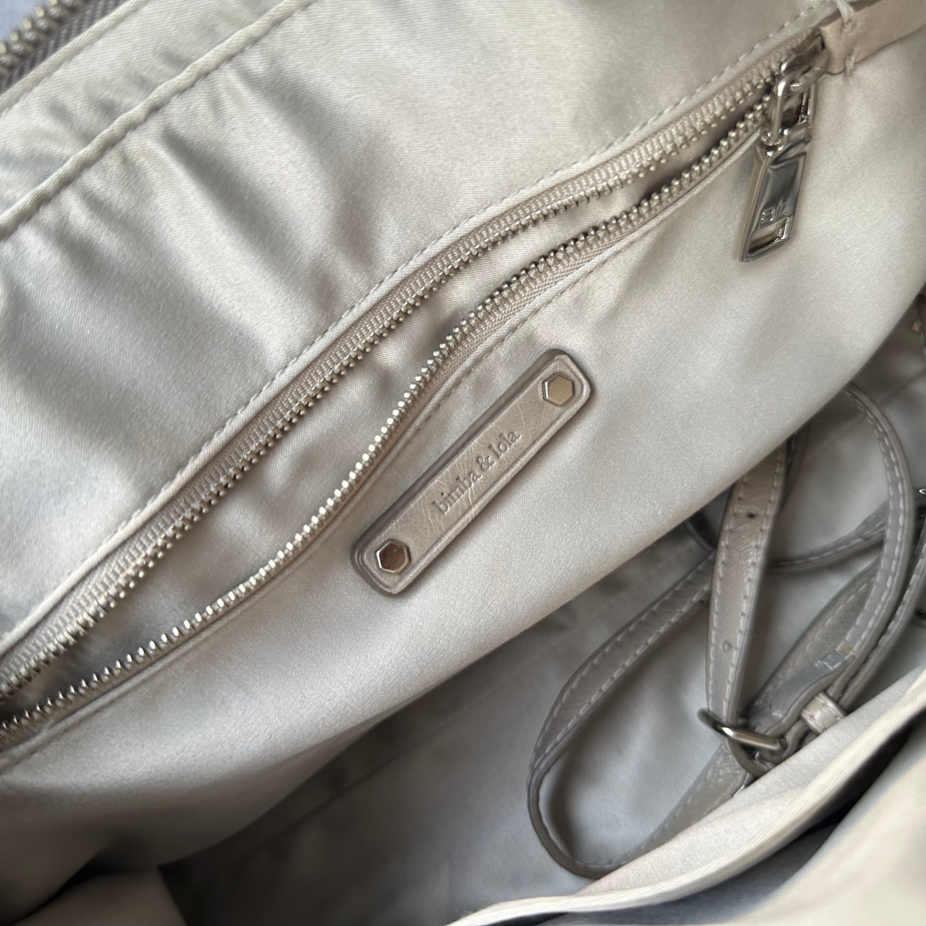 Close-up of Bimba & Lola interior logo tag and zipper pocket