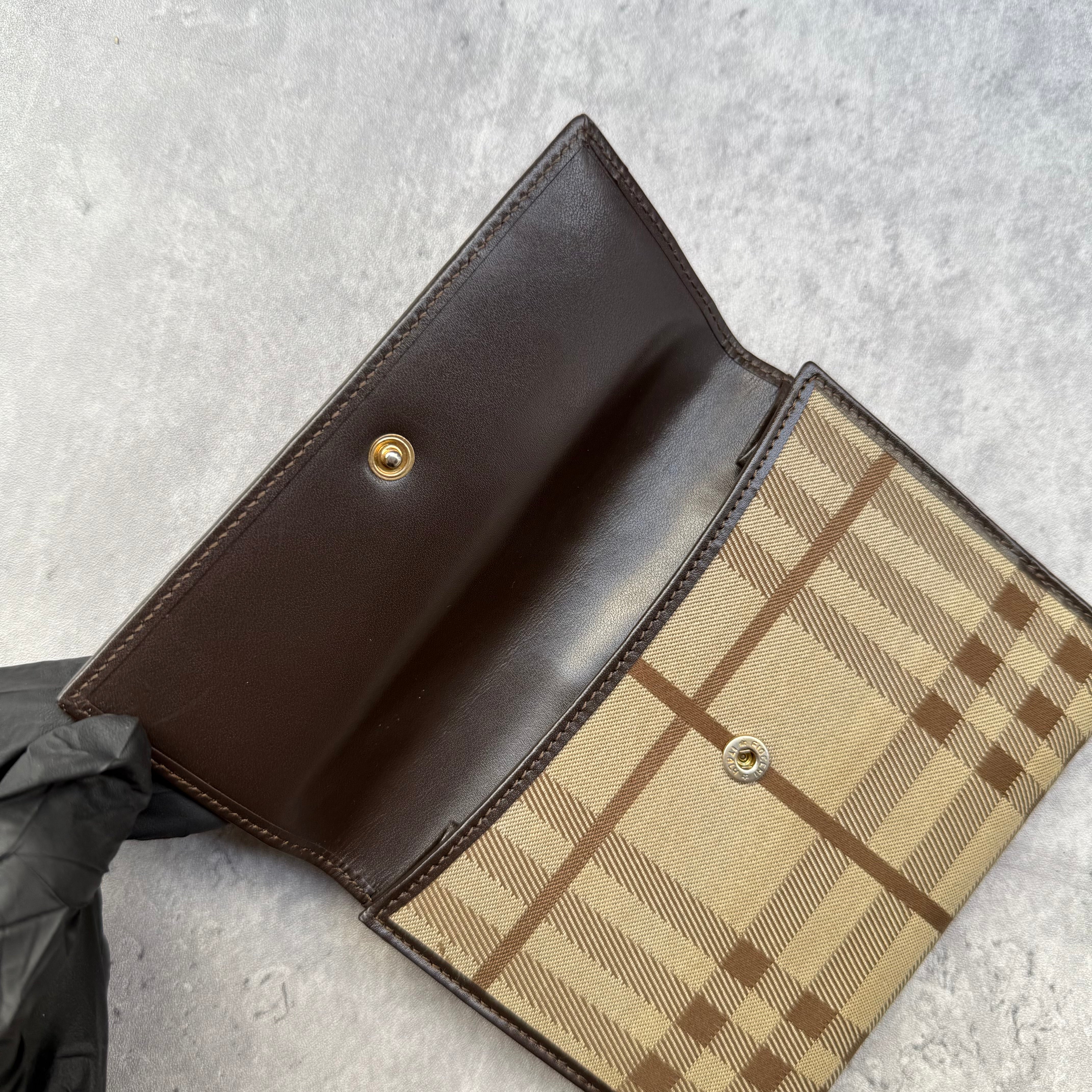 Burberry Nova Check Wallet in beige tartan canvas with brown leather trim, fold-out design, and multiple compartments.