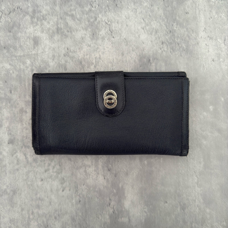 Bvlgari Doppio Tondo Bifold Long Wallet in black leather, featuring a silver-tone logo clasp, red fabric interior, and multiple compartments.