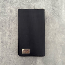 Bvlgari Ribbed Nylon Long Bifold Wallet in black with a silver-tone metal plaque logo, featuring multiple compartments and a sleek ribbed texture.