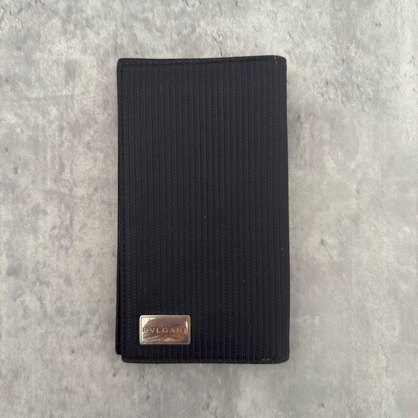 Bvlgari Ribbed Nylon Long Bifold Wallet in black with a silver-tone metal plaque logo, featuring multiple compartments and a sleek ribbed texture.