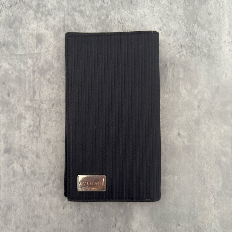 Bvlgari Ribbed Nylon Long Bifold Wallet in black with a silver-tone metal plaque logo, featuring multiple compartments and a sleek ribbed texture.