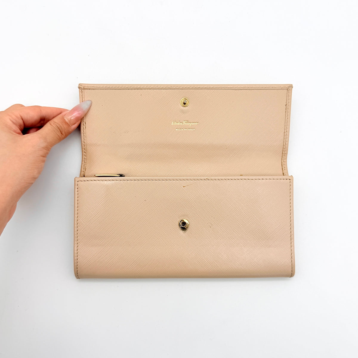 Salvatore Ferragamo light pink Saffiano wallet with gold Gancini hardware, shown on a white background.