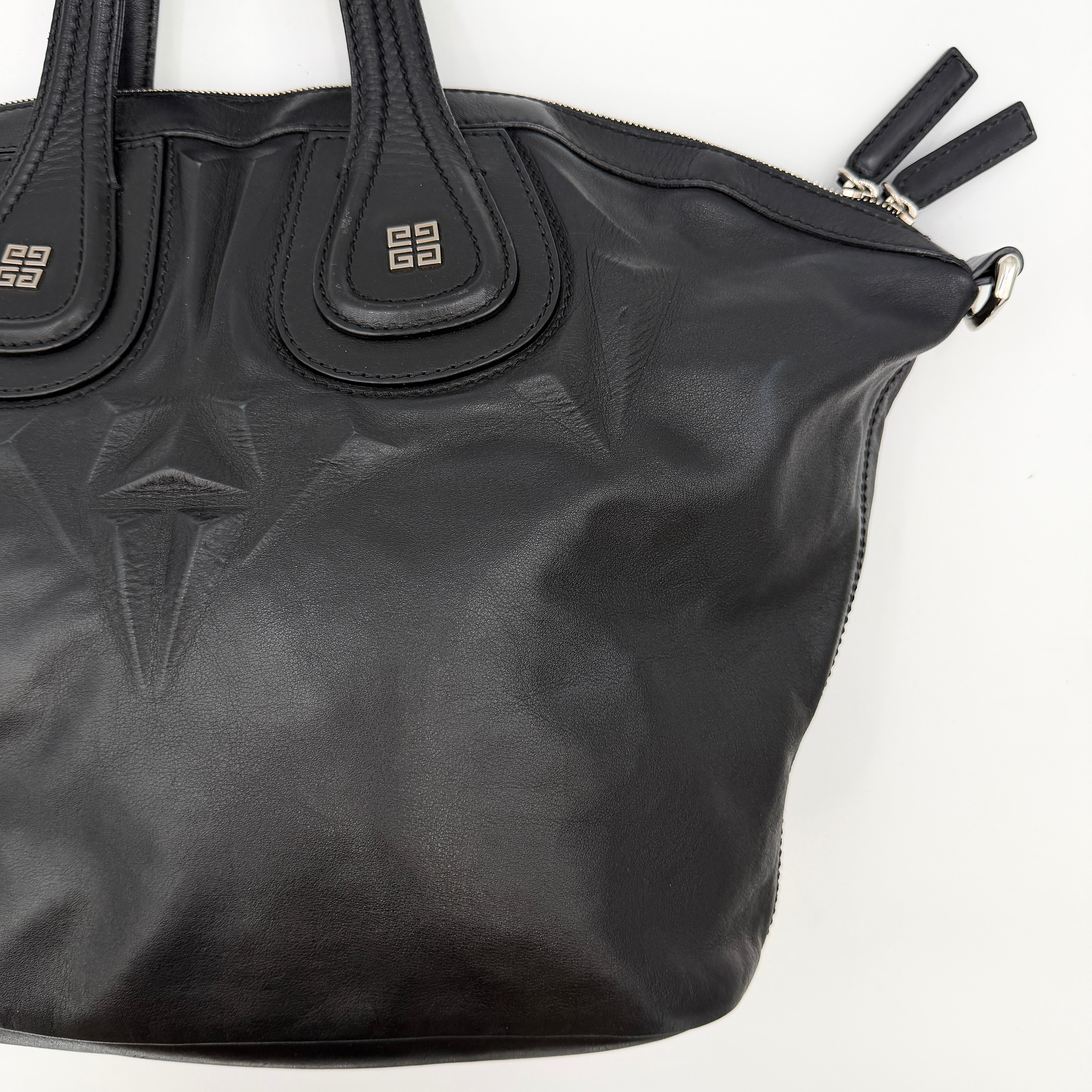 Givenchy 2Way Nightingale Handbag in black leather with detachable strap and striking front motif.