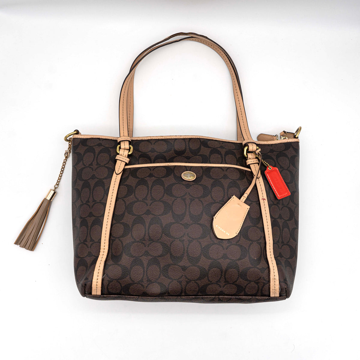Coach Signature Peyton Pocket tote bag in brown canvas with tan leather trim, shown with both handles and detachable strap.