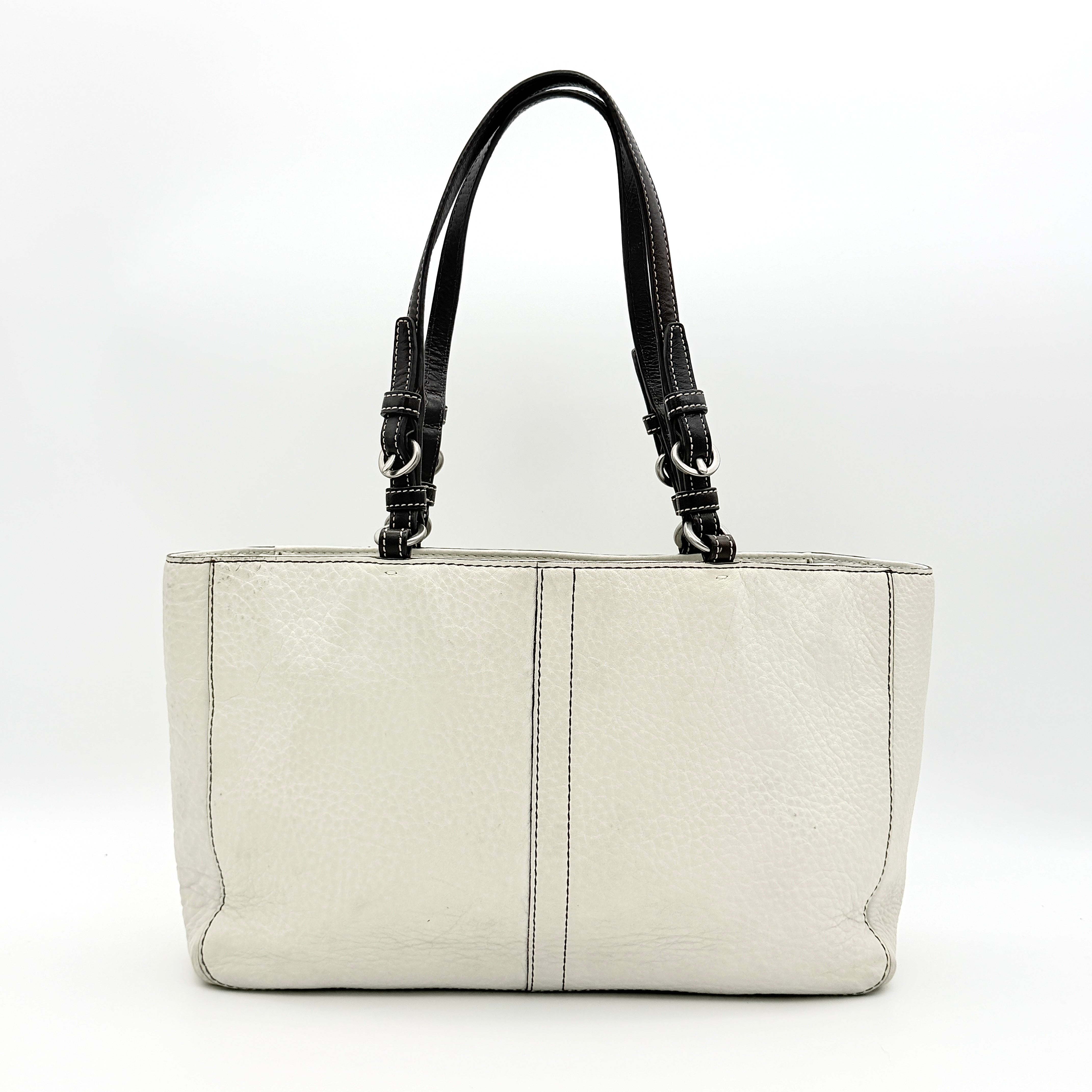 Coach Chelsea Shoulder Bag in ivory leather with black handles and front pocket, photographed against a white background.
