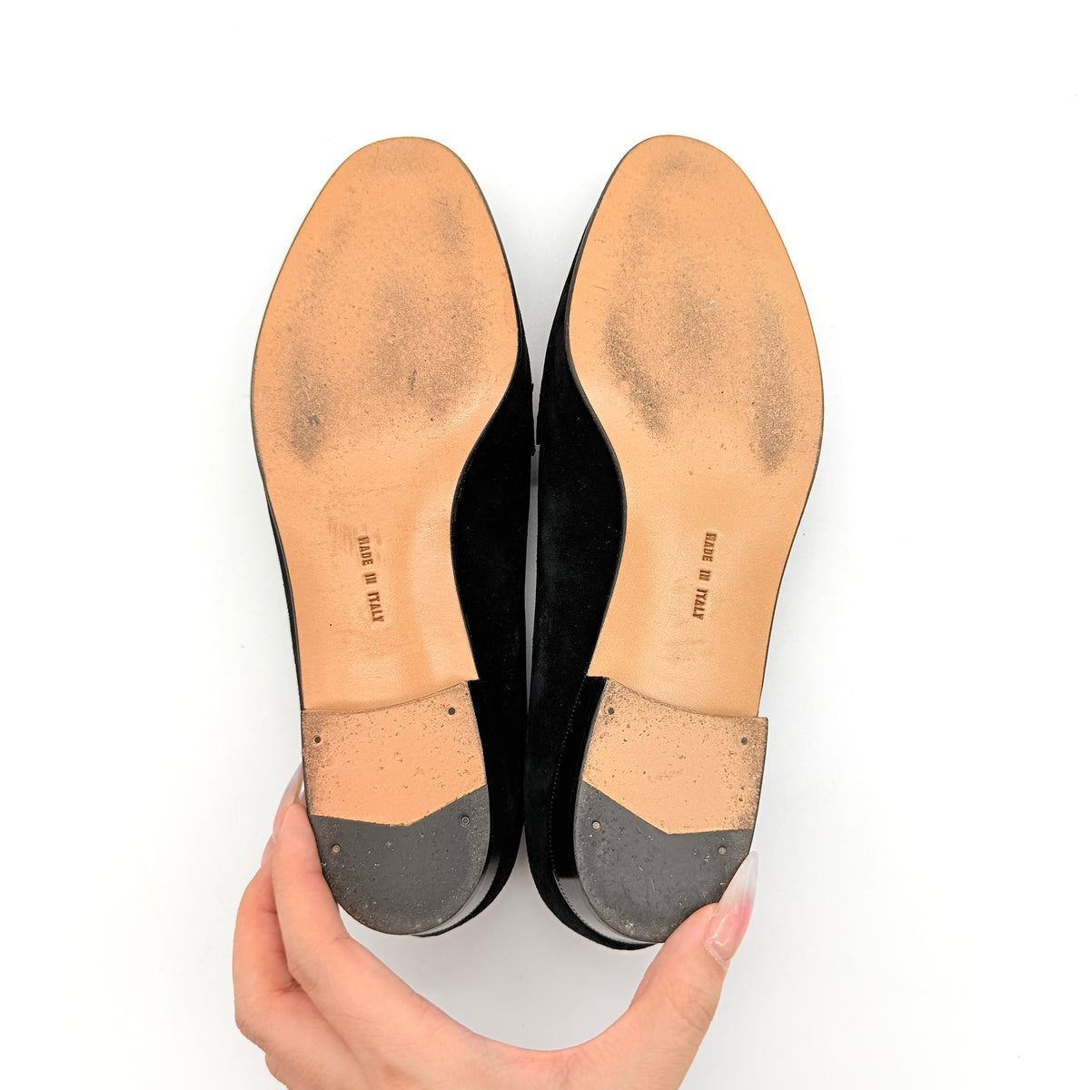Salvatore Ferragamo black suede loafers with gold Gancini horsebit detail, displayed side by side on a white background.