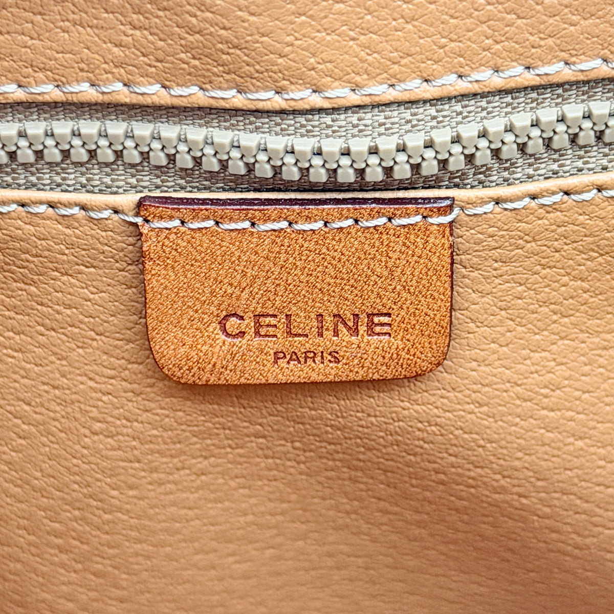 Celine Triomphe Macadam Clutch Bag in brown coated canvas with leather trim, shown against a white background.