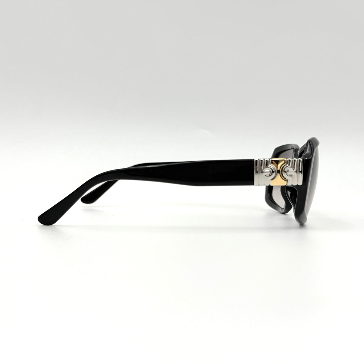 Bvlgari 829 501/11 black sunglasses with silver and gold temple hardware, displayed with case and cleaning cloth.