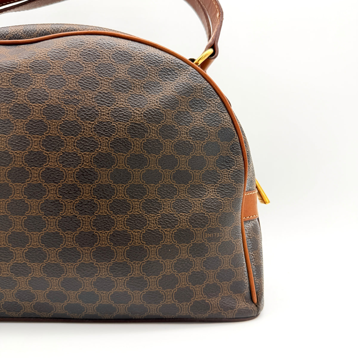 Front view of the Celine Triomphe Macadam Dome Handbag in brown, featuring the signature monogram canvas and tan leather details.