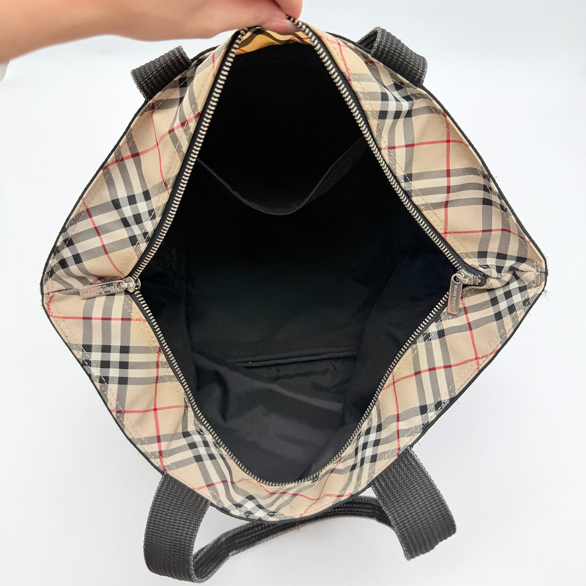 Burberry Blue Label Nova Check tote bag in black nylon with beige checked base and webbed handles, shown on white background.