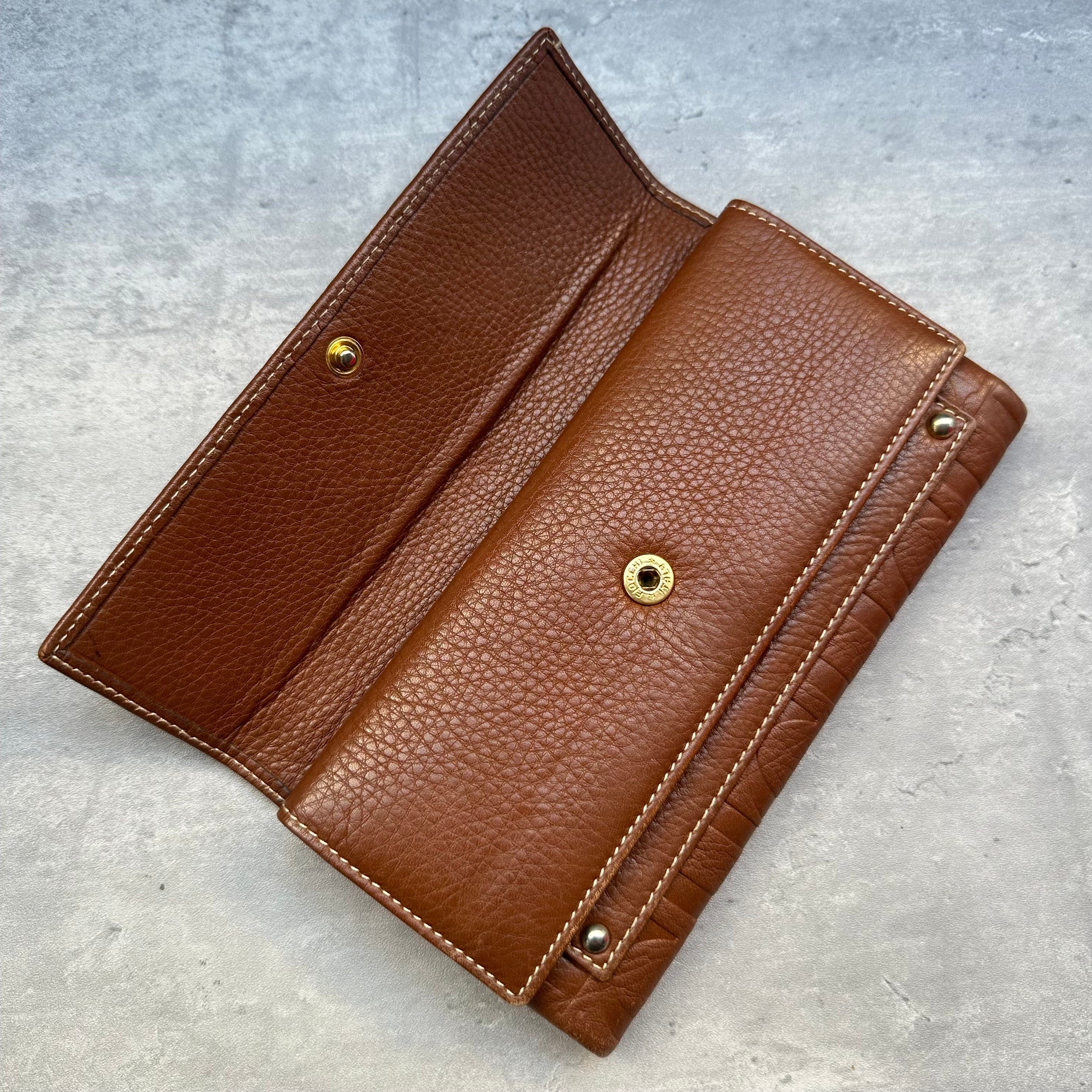 Detail of Carolina Herrera wallet exterior flap pocket and interior logo stamp